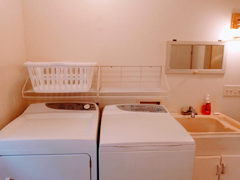 Washer and dryer in largest bathroom with laundry tub