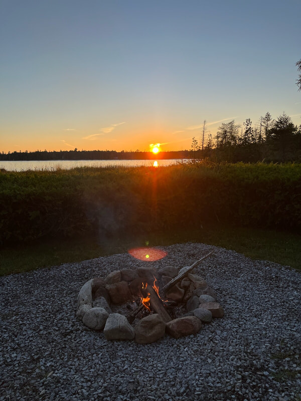 Relax by the glowing fire while enjoying the glowing sunset over Lake Huron.